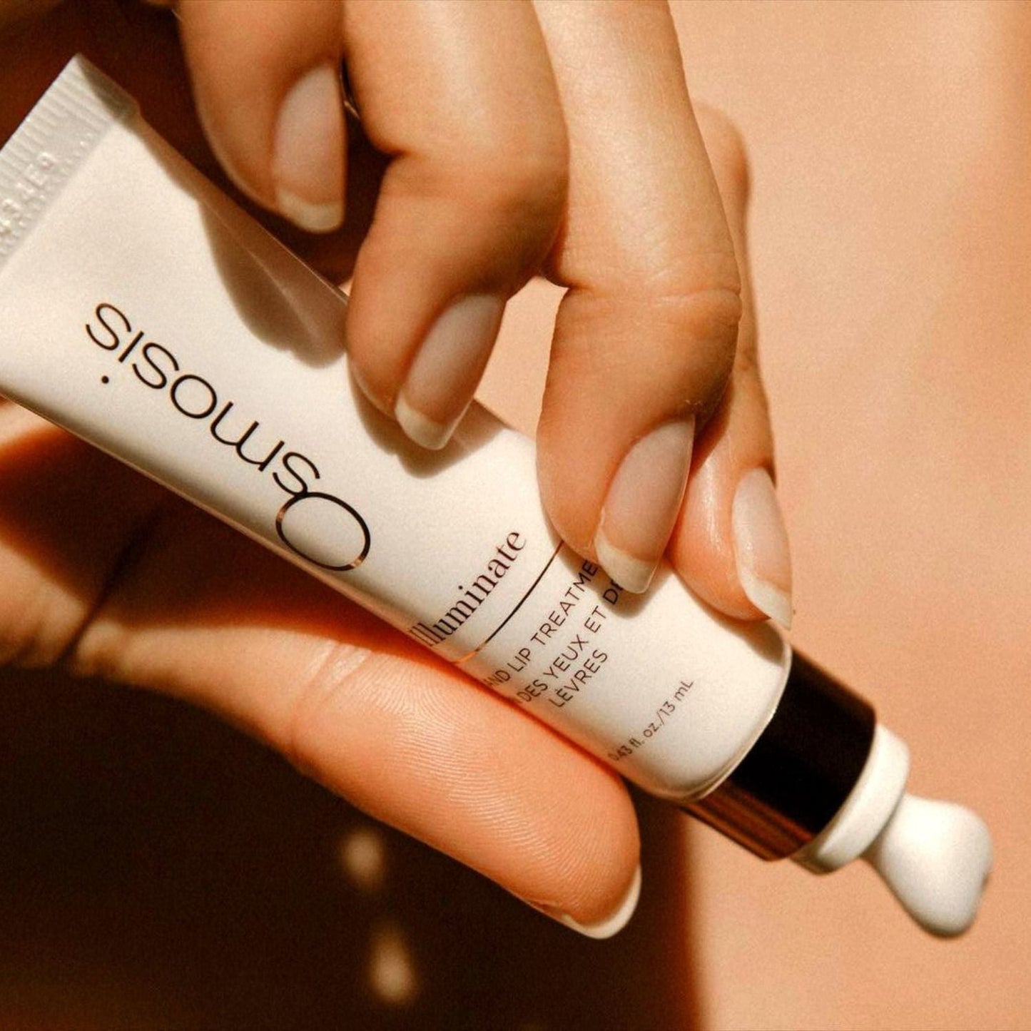 model squeezing out beauty product on skin