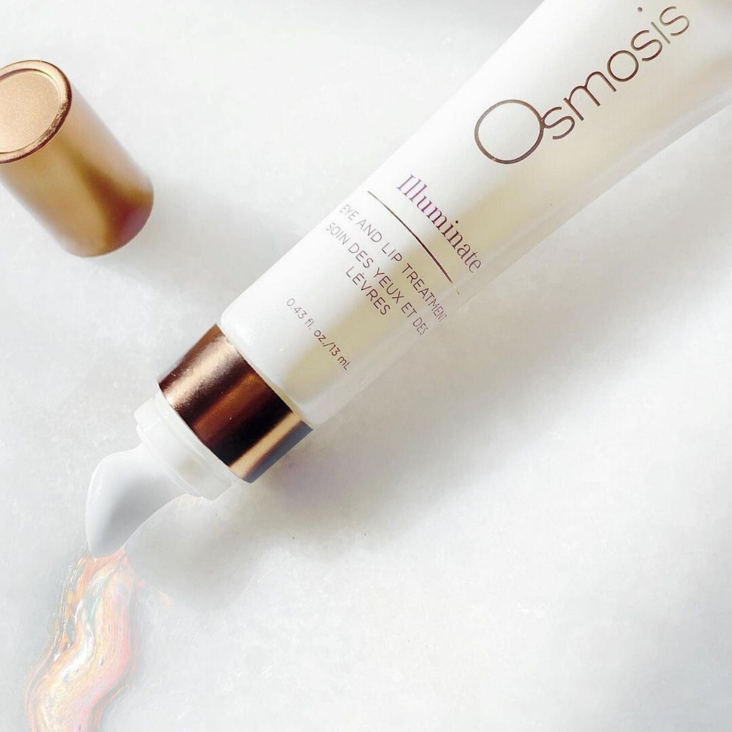 osmosis beauty skincare product laid out on white table with cap off