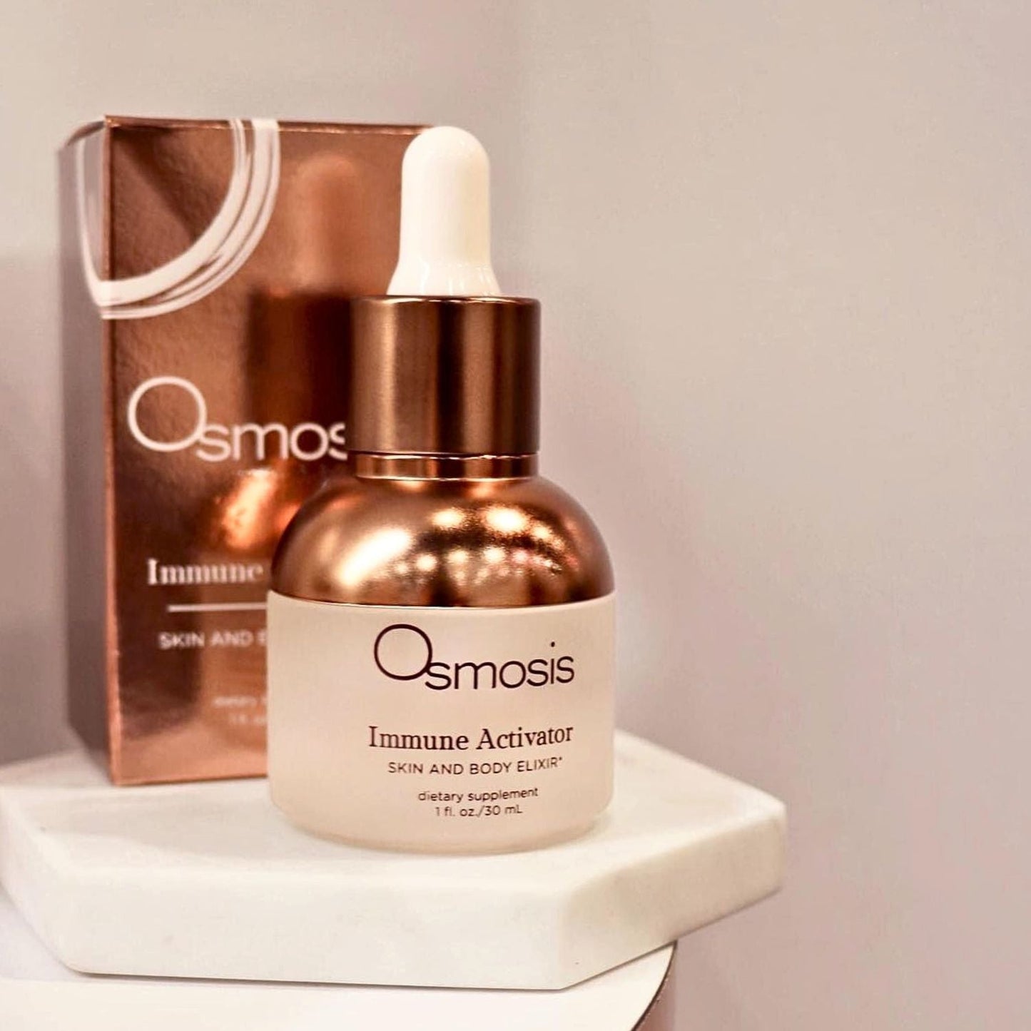 osmosis immune activator bottle with dropper and the box it comes in is displayed on white counter