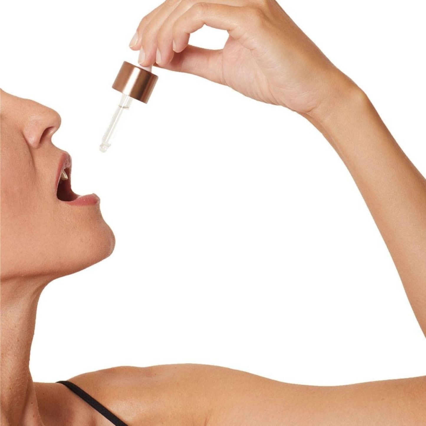 close up of model using dropper to ingest immune activator elixir by osmosis