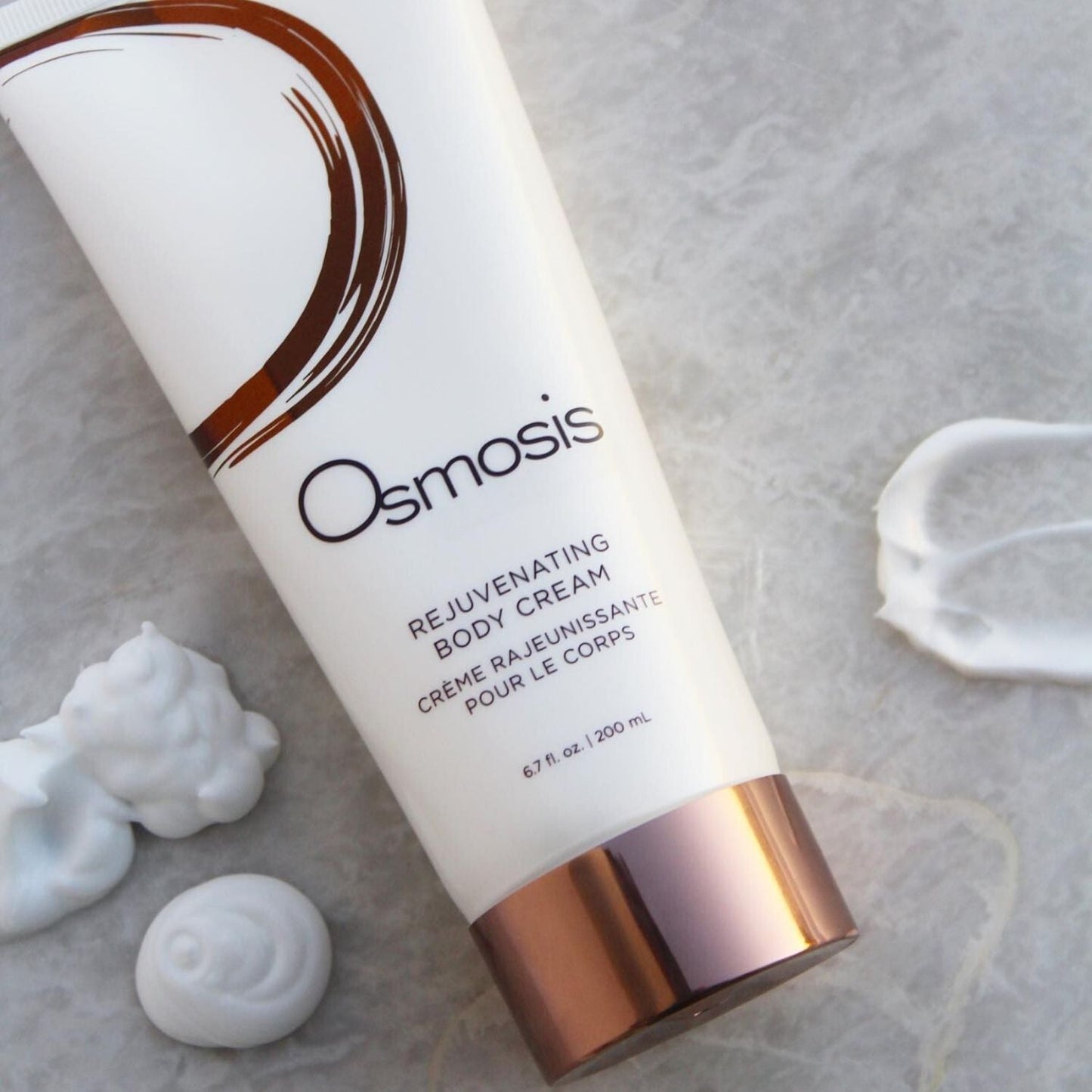 osmosis beauty product laying on countertop with products squeezed out