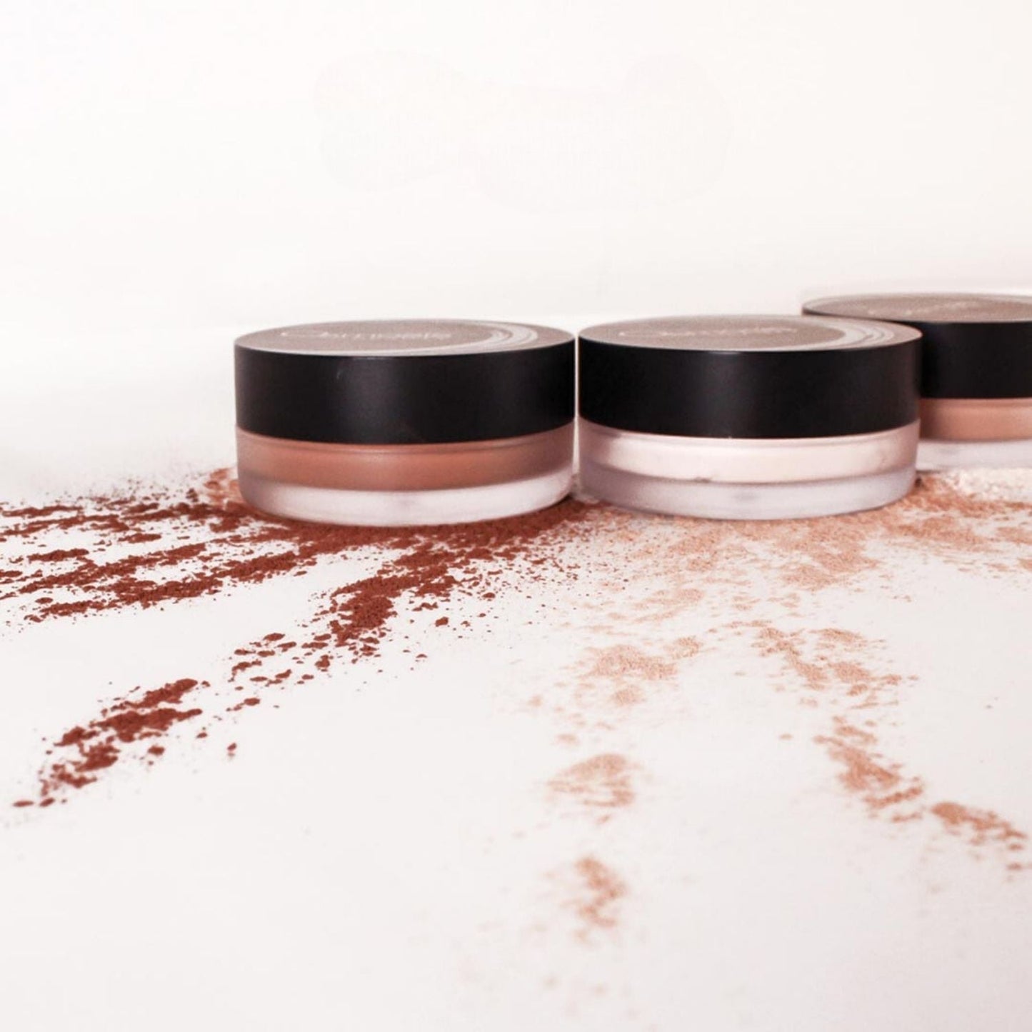 three powders on a countertop with powder displayed