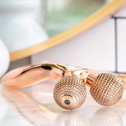 side ways views of rose gold epic skin tool displayed on counter
