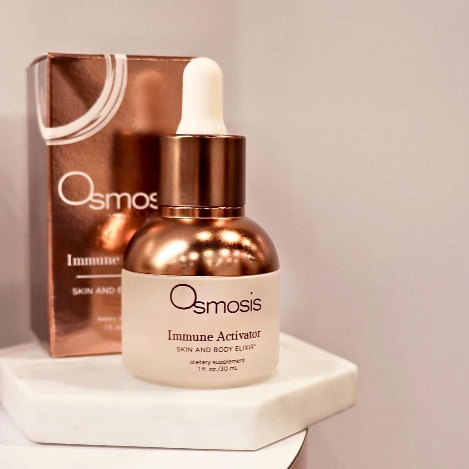osmosis immune activator bottle with dropper and the box it comes in is displayed on white counter