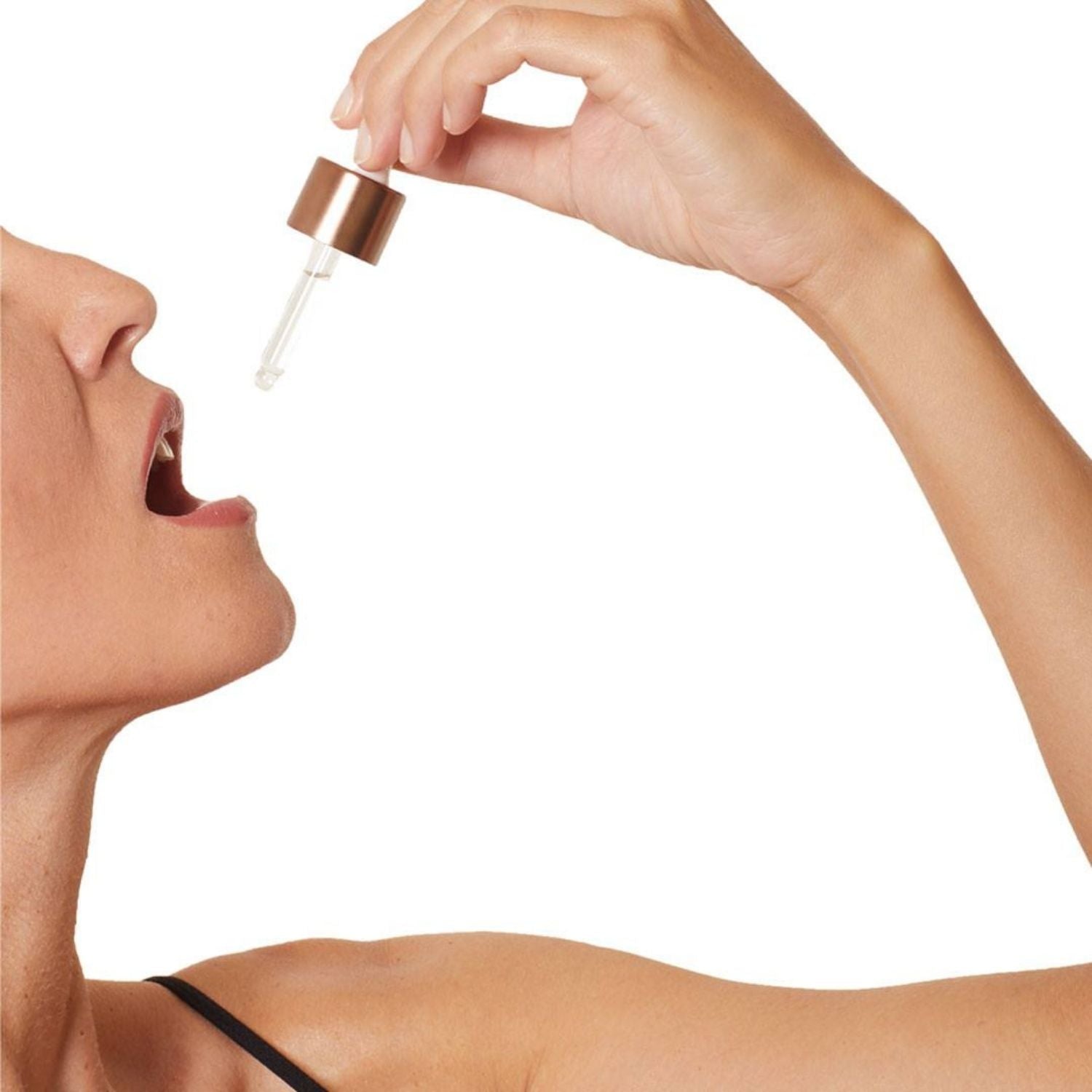 close up of model using dropper to ingest immune activator elixir by osmosis